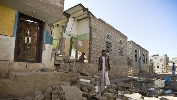 A Yemeni man near his house destroyed by Saudi air strikes near Sanaa airport.