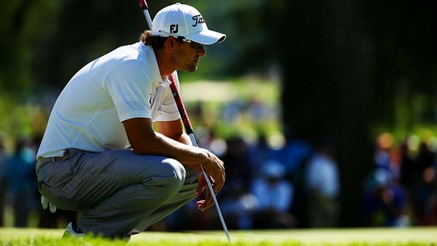 Adam Scott lines up a putt during the third round of the 95th PGA Championship on Saturday.