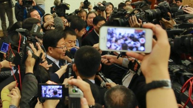 Huge interest ... Chinese Communist Party leader of Xinjiang, Zhang Chunxian, is met by a media scrum after he defended the government's hard-line policies in the country's far west.