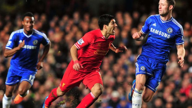 Luiz Suarez (C) clashes with Chelsea's English defender Gary Cahill (R).