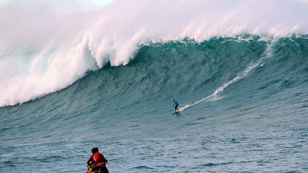 Daredevil: a man surfs a giant wave off the coast of France.