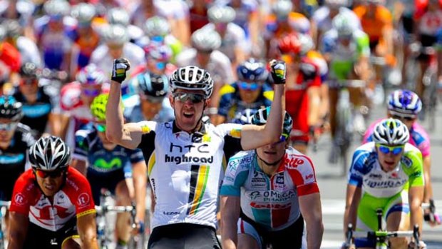 Matt Goss from Australia celebrates as he wins stage one  ahead of sprint rival and reigning champion Andre Greipel (R) and fellow Australian Robbie McEwen (L).