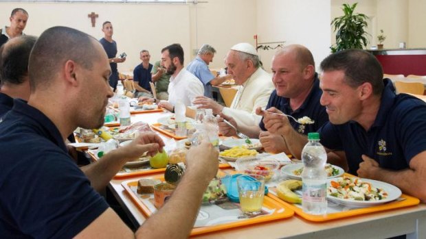 The Pope sits down with Vatican workers in the staff canteen.