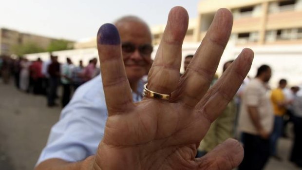 An Egyptian shows he has voted at a polling station in Cairo.