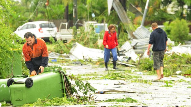 Residents pick up the pieces after a destructive storm described as 'worse than Yasi' tore off roofs, brought down power lines and left people injured.