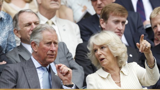 Prince Charles and wife Camilla watch the match.