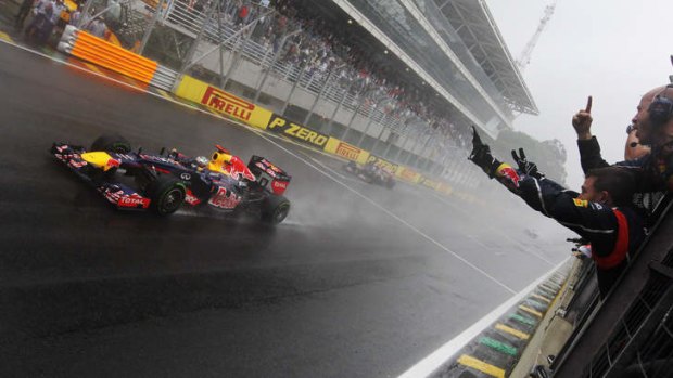 Sebastian Vettel's Red Bull teammates celebrate as he clinches the drivers' world championship in Brazil.