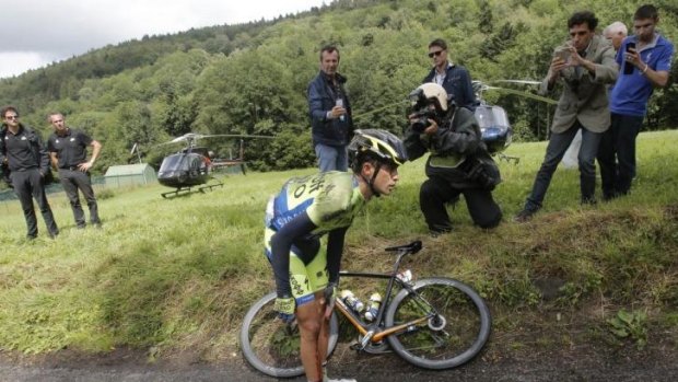 Down and out: Spain's Alberto Contador holds his knee after crashing on the 10th stage.