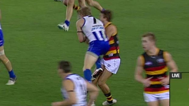 North Melbourne's Jack Ziebell clatters into Adelaide's Jarryd Lyons in the teams' match at Etihad Stadium on Sunday.
