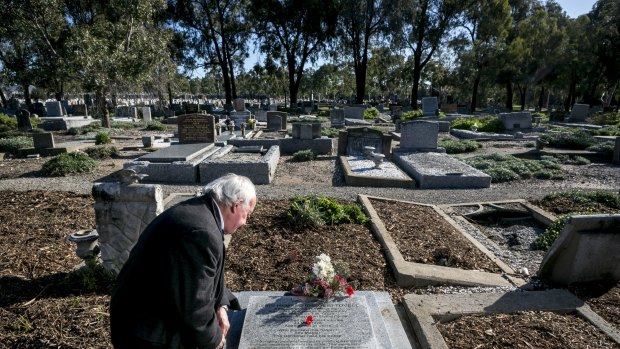 Anthony Hill, author of the new book Young Digger, pictured at Fawkner cemetery, Melbourne, at the grave of Henri Hemene Tovell, the French orphan smuggled from Europe by Australian airmen after World War I.