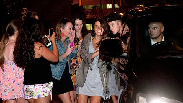 Justin Bieber arrives in Brisbane but stops for some selfies with fans.