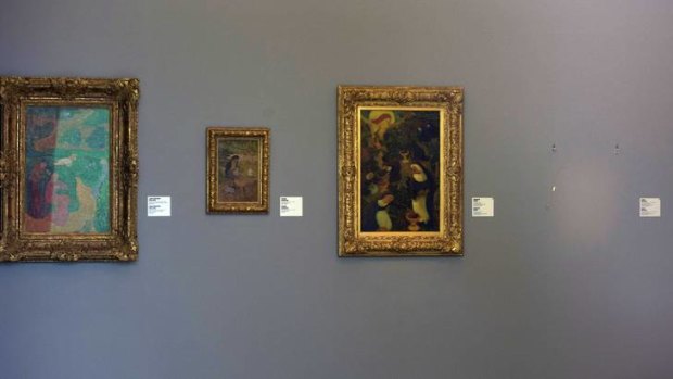 The empty space where Henri Matisse' painting "La Liseuse en Blanc et Jaune" was hanging, right, is seen at Kunsthal museum in Rotterdam, Netherlands.