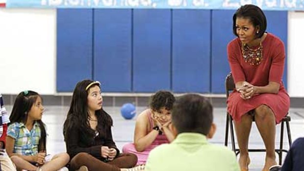 Michelle Obama talks to  students, including the girl, far left, who revealed her mother did not have papers to be in the States.