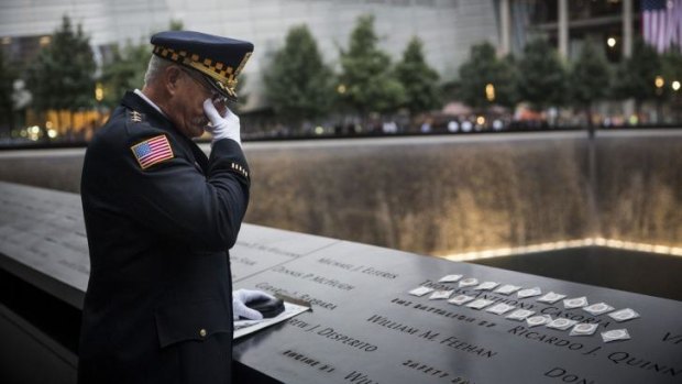 Sam Pulia, mayor and a former police officer of Westerchester, Ilinois, mourns over the name of his cousin, New York firefighter Thomas Anthony Casoria, who was killed in the South Tower, at the site of the World Trade Centre.