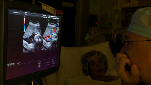 Alec Welsh examines Cristina's ultrasound.