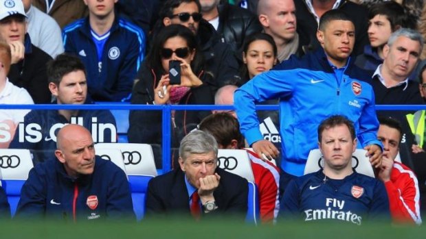 Tough viewing: Arsene Wenger watches on as Arsenal concedes six goals to Chelsea.