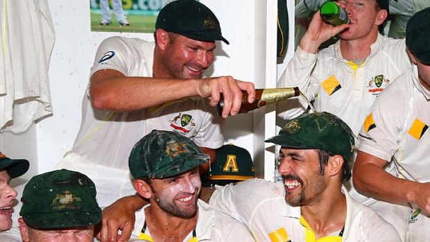 Ryan Harris pours beer on Mitchell Johnson as the Australian team celebrates in the change rooms after day five of the Third Test.