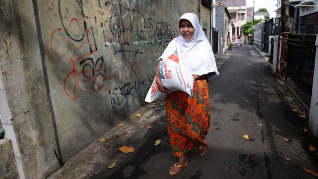 Suherti and her family are low-income residents of a central Jakarta neighbourhood who purchase rice at a subsidised price as part of the Raskin program.