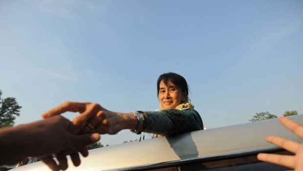 Visionary &#8230; opposition leader Aung San Suu Kyi waves to supporters in the district of Dawei.