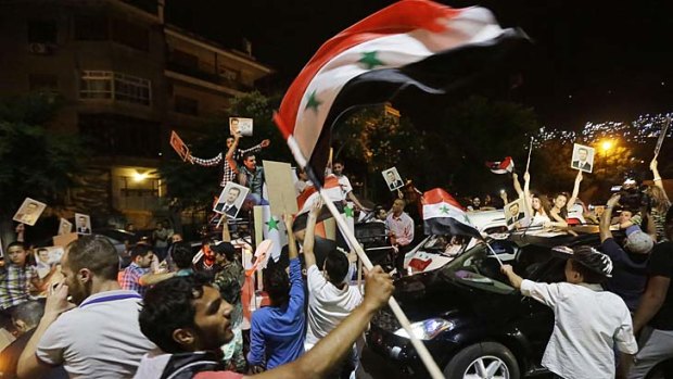 Syrians celebrate in the streets after President Bashar al-Assad was announced as the winner of the country's presidential elections.