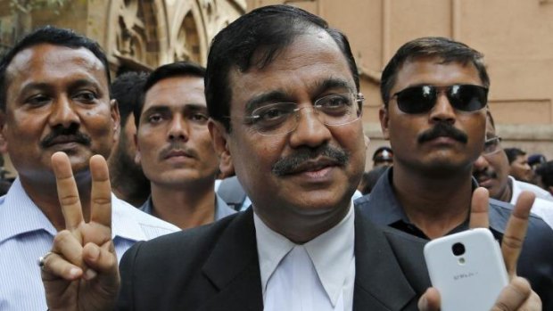 'This sends a strong signal to society': Public Prosecutor Ujjwal Nikam displays the victory symbol as he comes out of a court in Mumbai, India.