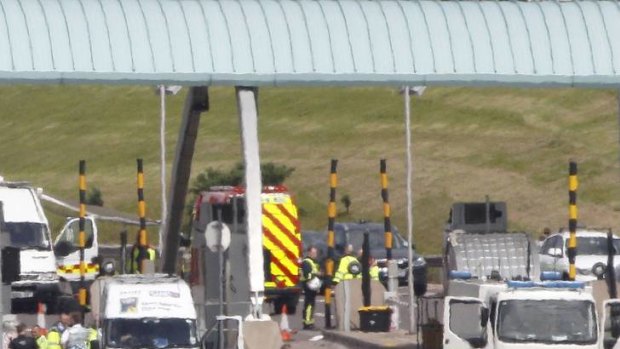 False alarm ... a man in protective clothing boards a coach as bomb disposal crews, firemen and police officers stand behind after it was stopped and surrounded on the M6.