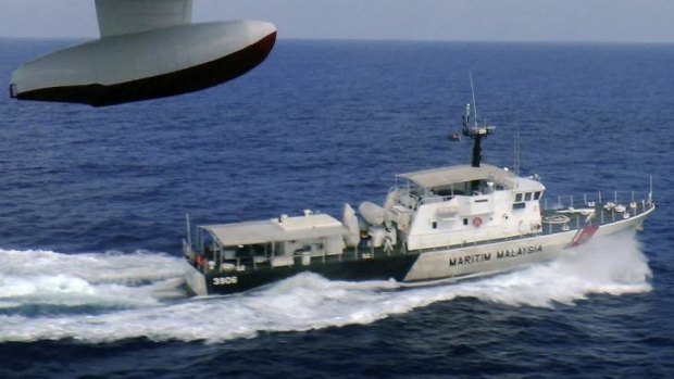 A patrol vessel of Malaysian Maritime Enforcement Agency searches for the missing Malaysia Airlines plane off Tok Bali Beach in Kelantan, Malaysia.