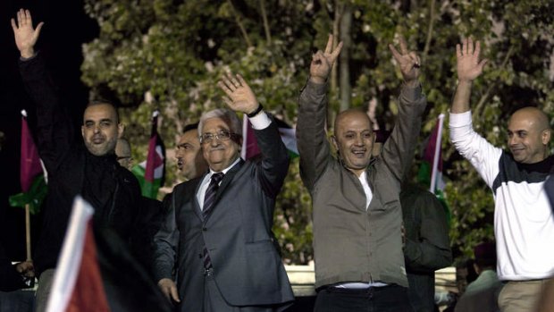 Welcome ceremony: Palestinian President Mahmoud Abbas, second left, and freed prisoners greet the crowd at the Palestinian Authority headquarters in the West Bank city of Ramallah.