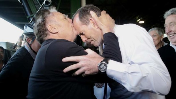 A head smacker: Nino Barbaro greets Tony Abbott at Sydney Markets.