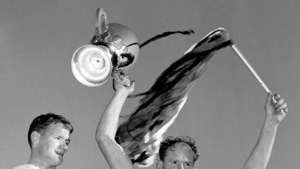 Darrel Baldock flying high with the Saints' only premiership cup in 1966.