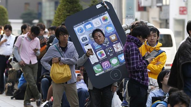 Japanese iPhone fans wait in line to purchase Apple's new iPhone 5S at Tokyo's Ginza shopping district last Friday.
