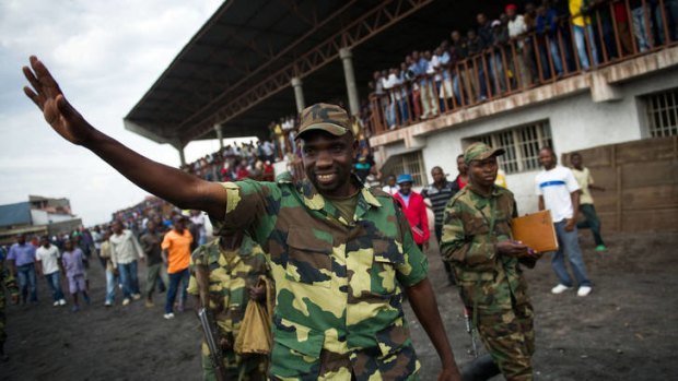 'We will go to Kinshasa' ... Lieutenant-Colonel Vianney Kazarama waves at a crowd as he arrives at the Volcanoes Stadium in Goma.
