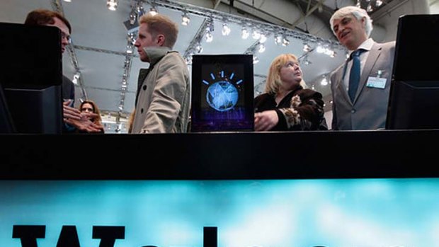 Visitors check out a slimmed down version of the IBM Watson supercomputer at the CeBIT technology fair in Hanover, Germany, on March 2, 2011.