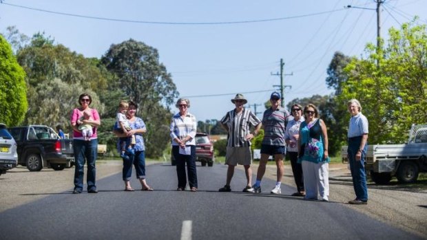 Gundaroo residents who oppose two proposals for residential development on either side of the village, standing on the main road.