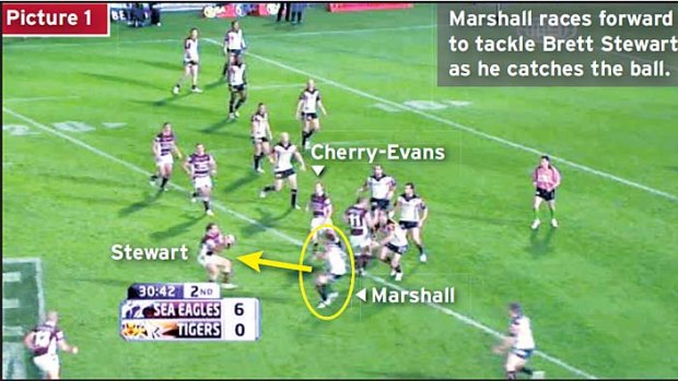 Picture 1 ... Marshall races forward to tackle Brett Stewart as he catches the ball.