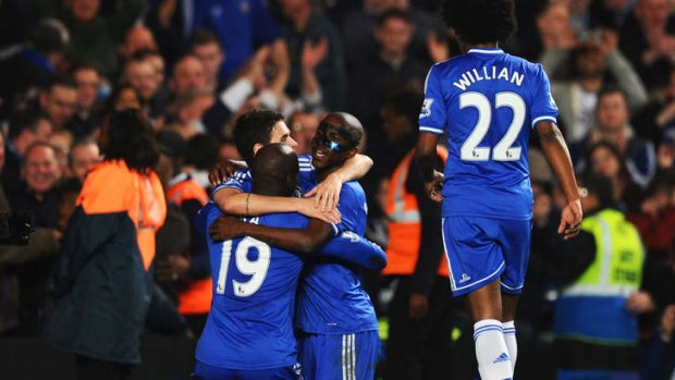 (L-R) Demba Ba #19 of Chelsea celebrates with teammates Oscar, Ramires and Willian after scoring his team's fourth goal.