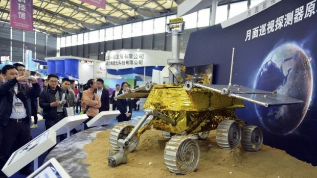 Public appeal: Visitors at a trade fair take pictures of a prototype model of a lunar rover in Shanghai in November.