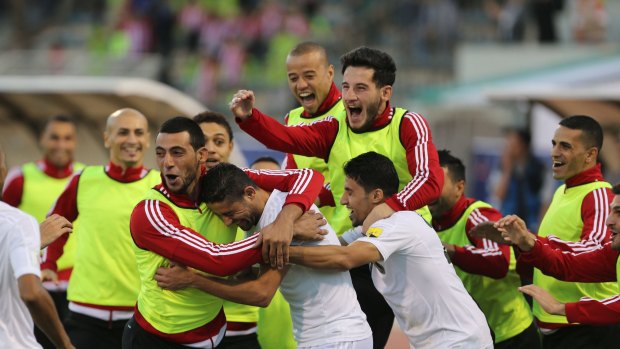 Jordanian players celebrate a goal during the 2018 FIFA World Cup qualification match against the Socceroos.