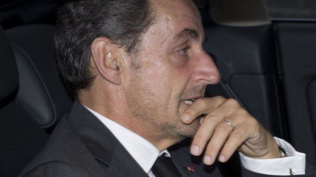 Nicolas Sarkozy leaves his office on Friday after announcing his return to politics on Facebook and Twitter.