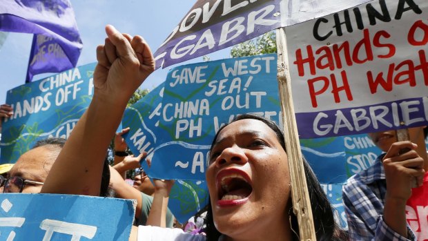 Protesters shout slogans during a rally outside the Chinese consulate in the Philippines hours before The Hague-based UN international arbitration tribunal was to announce its ruling.
