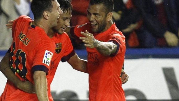 Neymar (C) celebrates his goal with Lionel Messi (L) and Dani Alves.