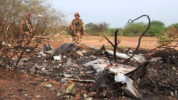 French soldiers standing by the wreckage of the Air Algerie flight AH5017, which crashed in Mali's Gossi region, west of Gao, on July 24.