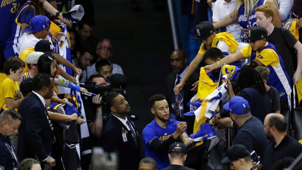 Golden State Warriors' NBA All-Star Stephen Curry signs autographs before Game 1 of the NBA Finals against the Cleveland Cavaliers on June 1.