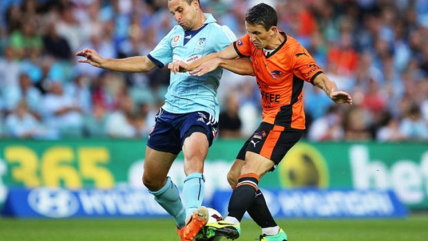Liam Miller of the Roar goes head to head with with Richard Garcia of Sydney FC.