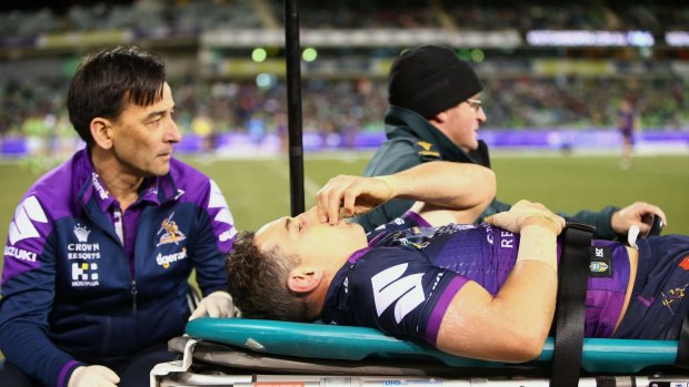 Awful sight: A concussed Billy Slater is assisted from the field.