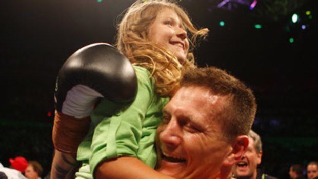 Well done dad . . . Danny Green gets a hug from his daughter Chloe after his one-round annihilation of Roy Jones jnr at Acer Arena last night.