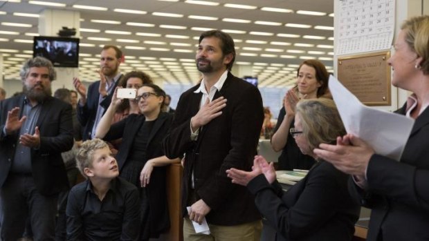 Honoured: Photographer Daniel Berehulak, centre, during a Pulitzer Prize award celebration in the newsroom at <i>The New York Times</i>.