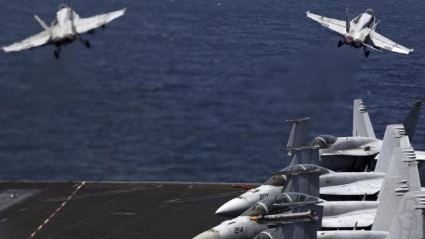 US F/A-18 Hornets take off from USS George H.W. Bush for a mission in Iraq last month.