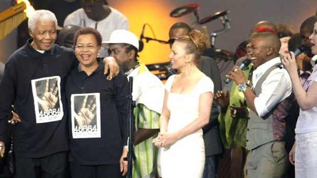 Former South African president Nelson Mandela with his wife Graca Machel attends the 46664 concert in honour of his 90th birthday in London.