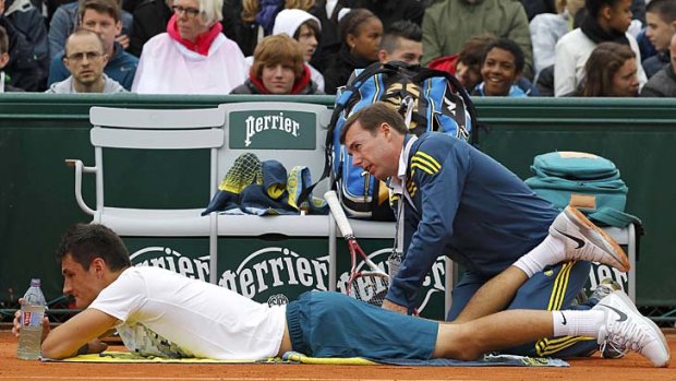 Bernard Tomic receives medical treatment during his men's singles match against Victor Hanescu of Romania.